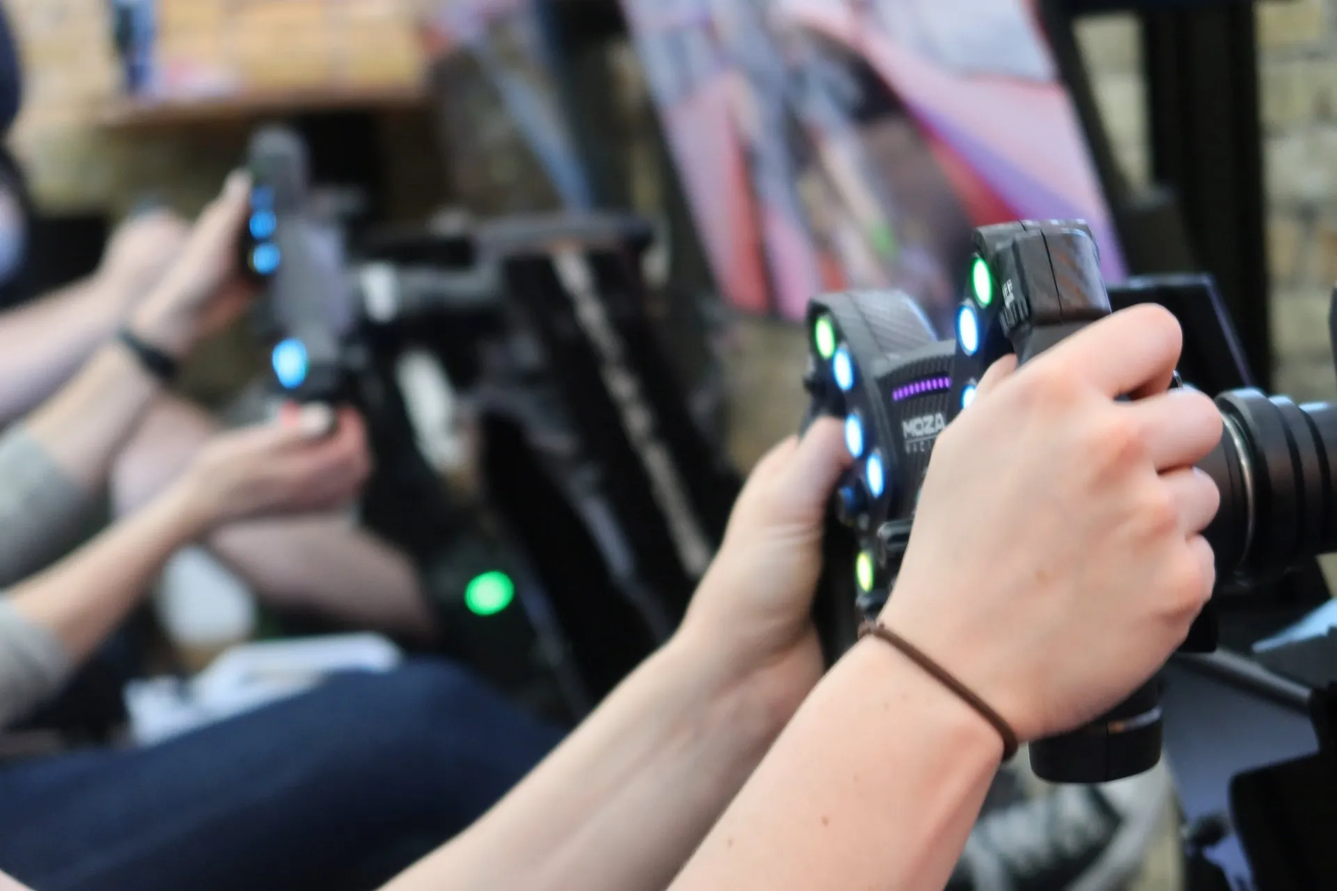 A driver’s hands on a Skid Mark simulator wheel during an event